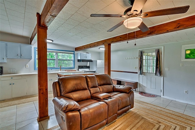 living room featuring ceiling fan, sink, and light tile patterned flooring