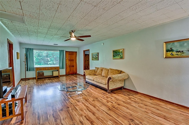 living room featuring ceiling fan and hardwood / wood-style flooring