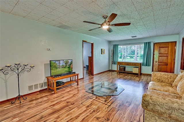 living room featuring ceiling fan and hardwood / wood-style floors