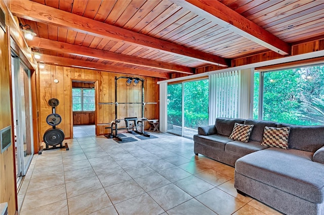 tiled living room with wooden ceiling, plenty of natural light, beamed ceiling, and wooden walls