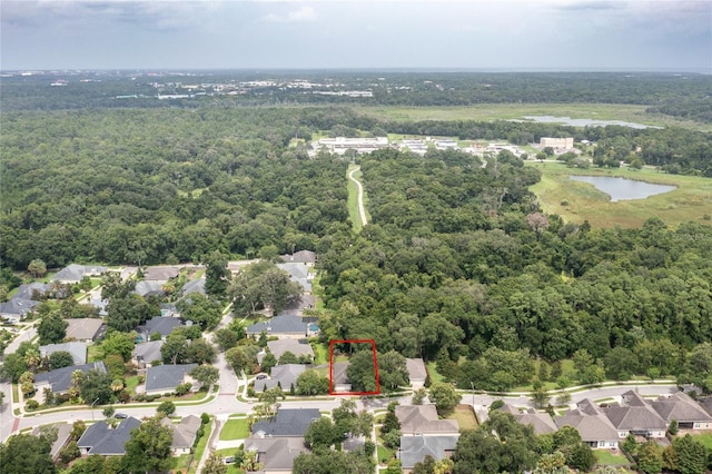 bird's eye view featuring a residential view, a water view, and a forest view