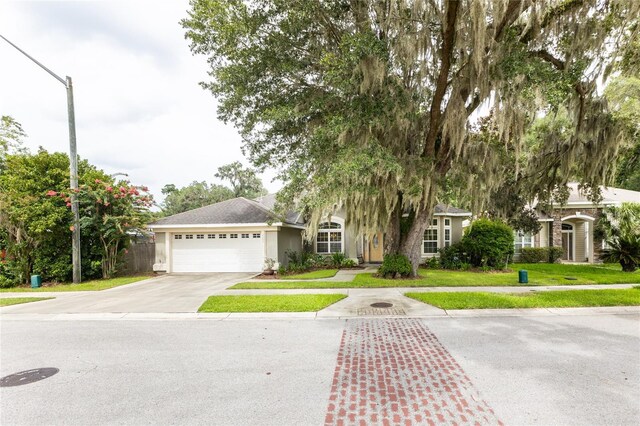 view of front of home featuring a garage and a front yard