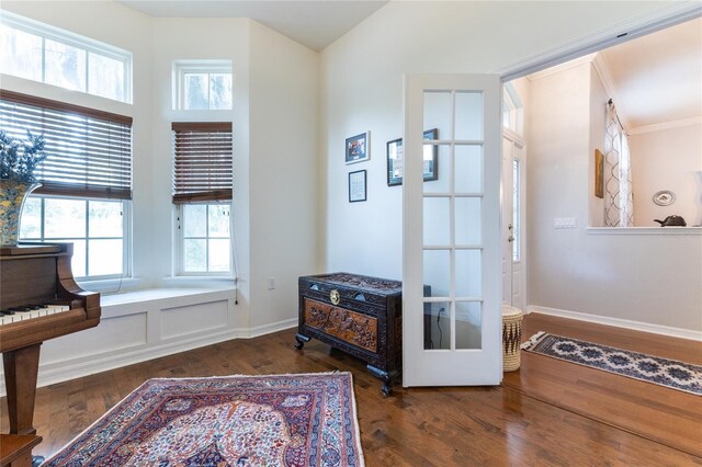 interior space with ornamental molding and dark hardwood / wood-style floors