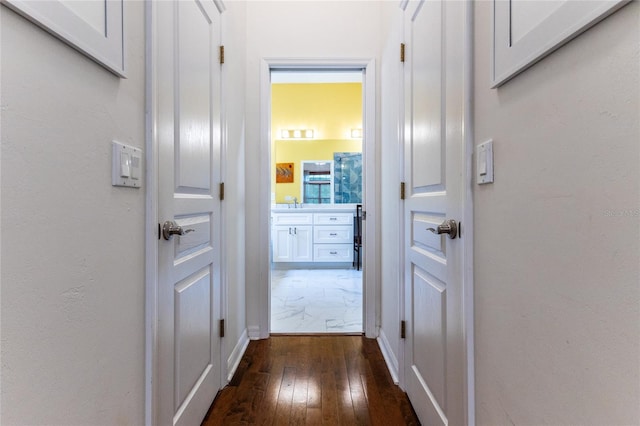 hall featuring dark hardwood / wood-style flooring and sink