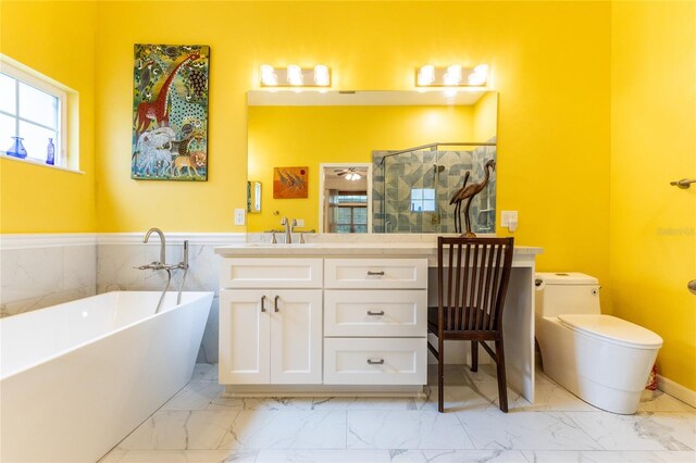 bathroom with vanity, tile patterned floors, toilet, and a bathtub