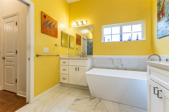 bathroom featuring a tub, tile patterned floors, and vanity