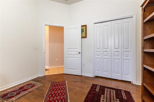 interior space with dark wood-type flooring and a closet