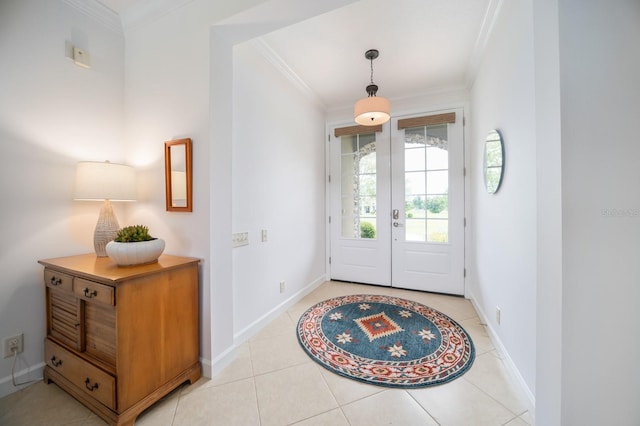 entryway with light tile patterned floors, crown molding, and french doors