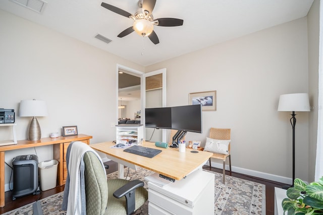 home office featuring ceiling fan and dark hardwood / wood-style flooring