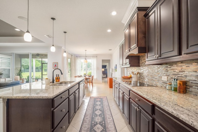 kitchen with decorative light fixtures, an island with sink, decorative backsplash, stainless steel dishwasher, and dark brown cabinets