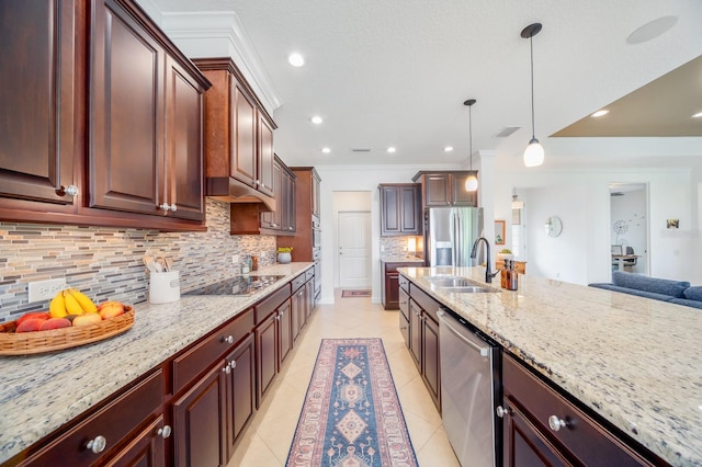 kitchen featuring decorative light fixtures, decorative backsplash, sink, crown molding, and appliances with stainless steel finishes