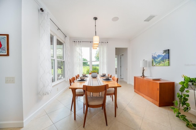 dining room with light tile patterned floors and ornamental molding