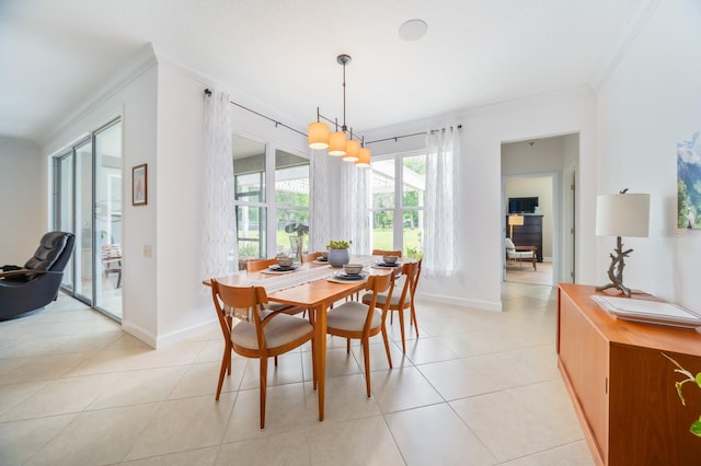 dining room featuring light tile patterned floors and crown molding