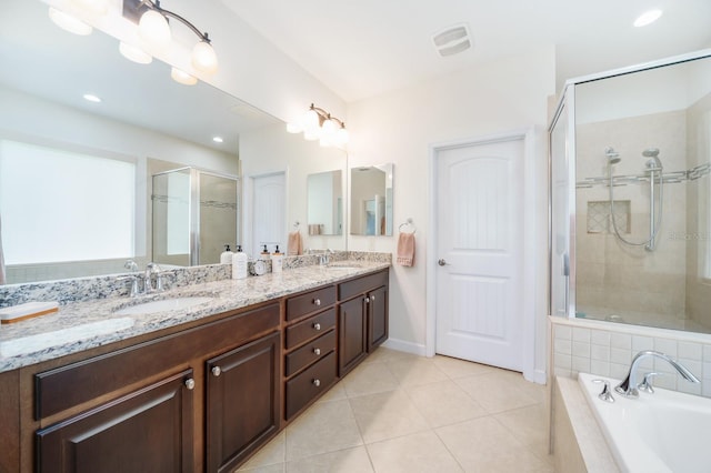 bathroom featuring independent shower and bath, tile patterned flooring, and vanity