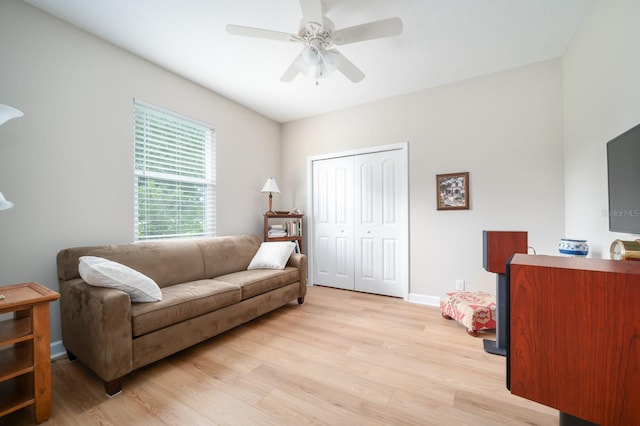 living room featuring ceiling fan and light hardwood / wood-style flooring