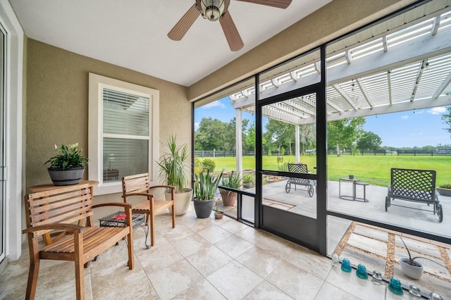 sunroom featuring ceiling fan