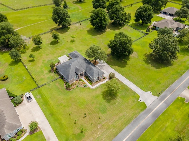 birds eye view of property with a rural view