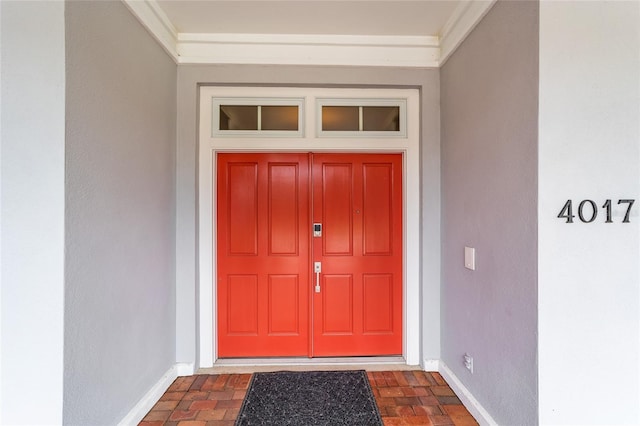 entrance to property with stucco siding