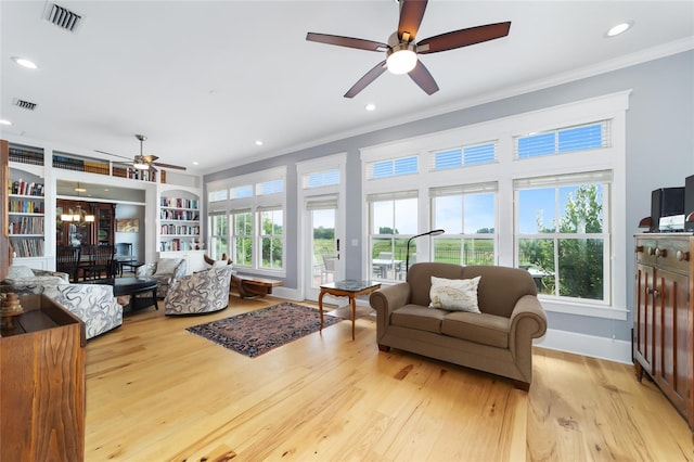 living room with light hardwood / wood-style flooring, ornamental molding, built in features, and ceiling fan