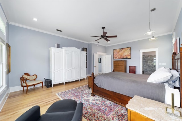 bedroom featuring ceiling fan, visible vents, baseboards, ornamental molding, and light wood finished floors