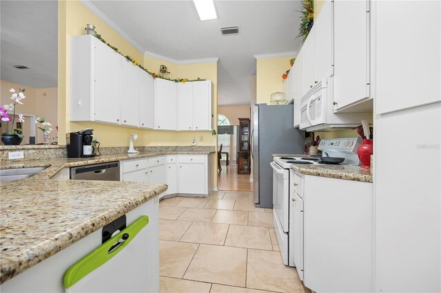 kitchen with white appliances, light tile patterned floors, white cabinets, light stone counters, and ornamental molding