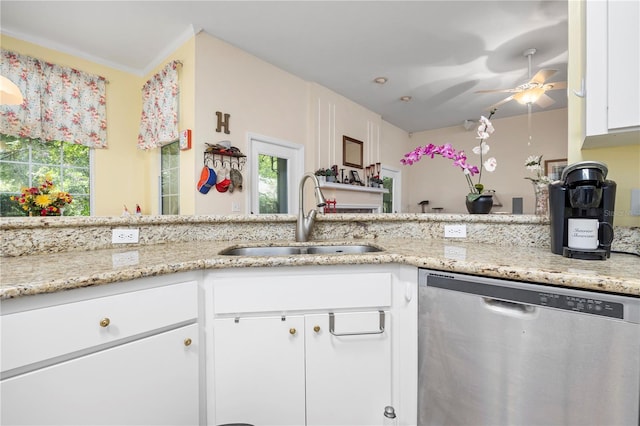 kitchen featuring white cabinetry, crown molding, ceiling fan, stainless steel dishwasher, and sink