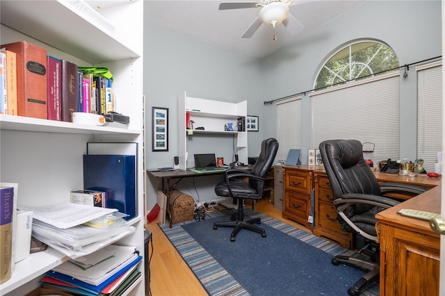 home office with light wood-type flooring and ceiling fan