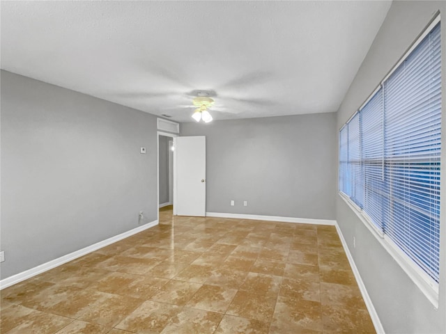 tiled empty room with ceiling fan