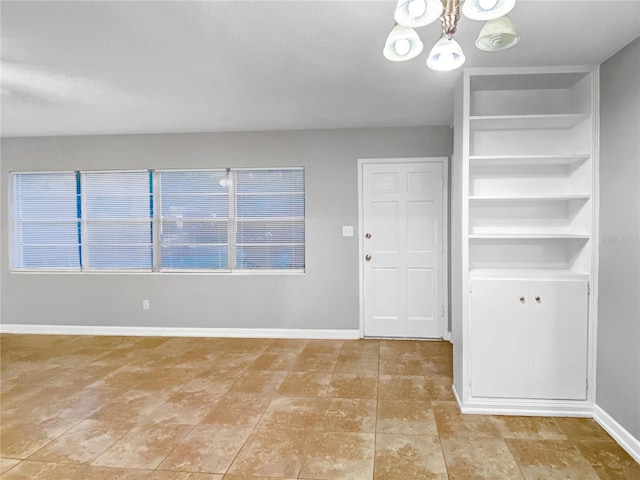 foyer with tile patterned flooring and an inviting chandelier