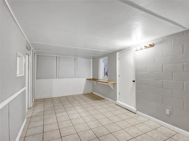 tiled spare room with a textured ceiling