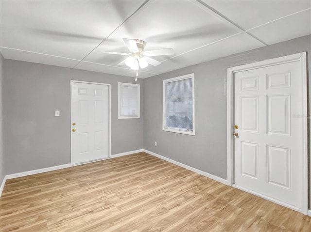 spare room featuring light hardwood / wood-style floors, ceiling fan, and a paneled ceiling