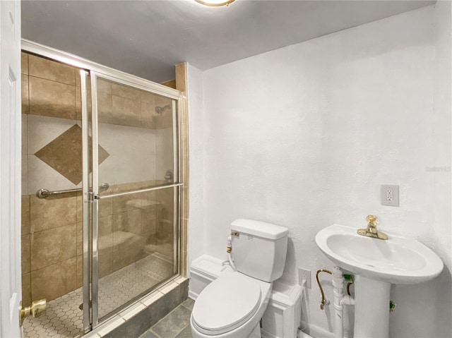 bathroom with a shower with door, tile patterned flooring, and toilet