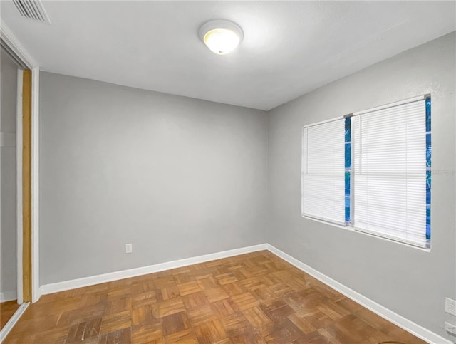 empty room with parquet flooring