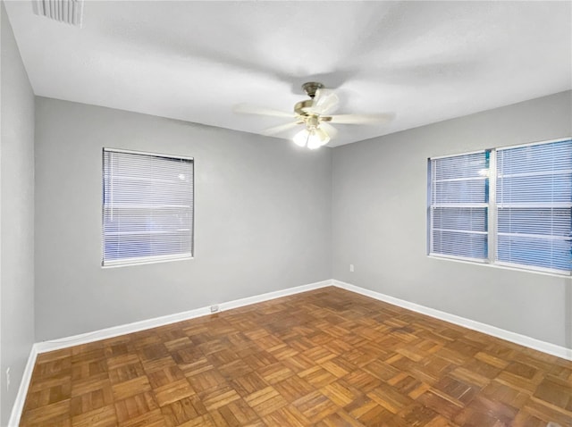 unfurnished room with parquet floors and ceiling fan