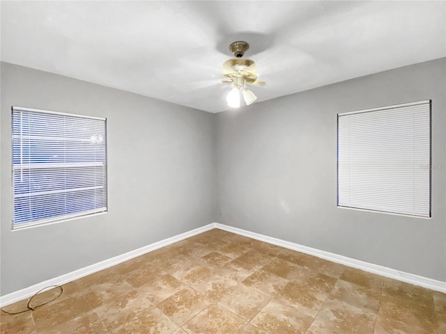 empty room with tile patterned flooring and ceiling fan