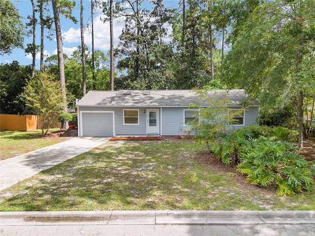 single story home with a garage and a front lawn