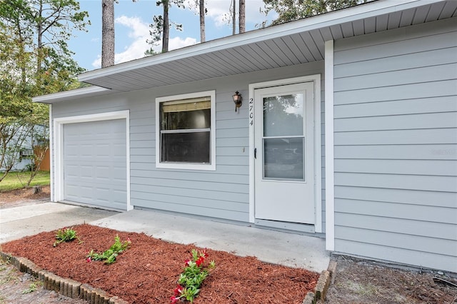 view of exterior entry featuring a garage