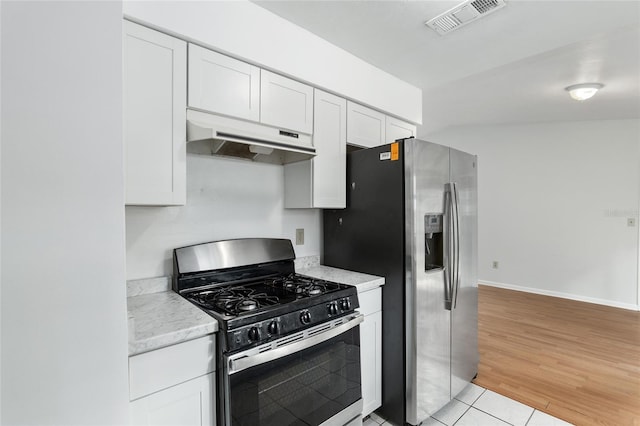 kitchen with light tile patterned floors, visible vents, white cabinets, stainless steel appliances, and under cabinet range hood