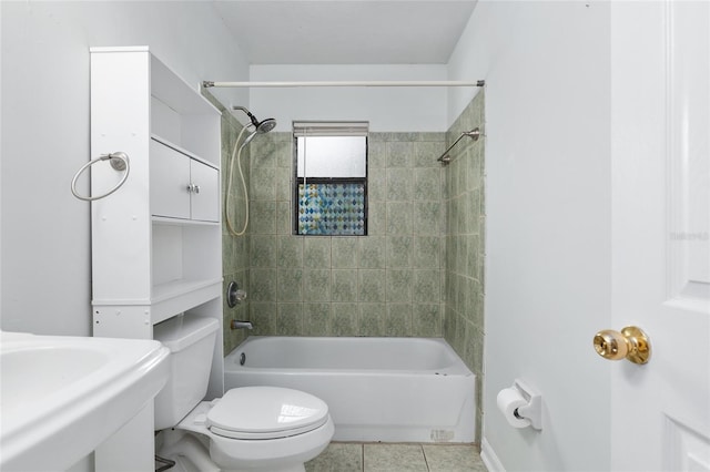 full bath with tile patterned flooring, tub / shower combination, a sink, and toilet