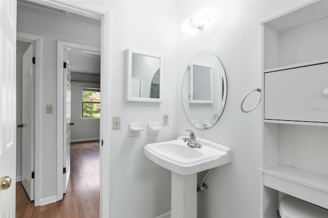 bathroom featuring wood finished floors and baseboards