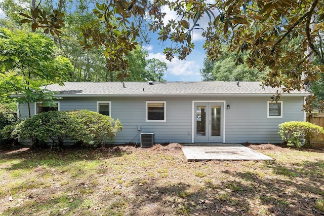 back of property with a yard, cooling unit, french doors, and a patio