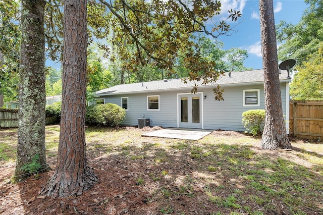 rear view of property featuring central AC, french doors, a patio, and fence