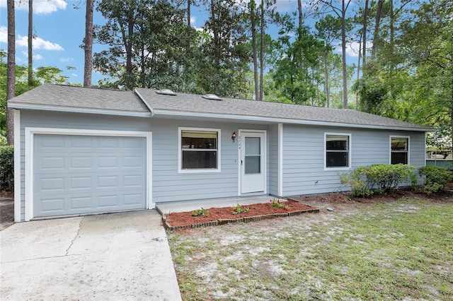 ranch-style home featuring an attached garage, driveway, and a shingled roof