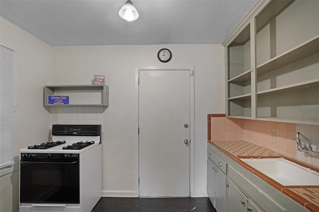 kitchen featuring decorative backsplash, white range with gas cooktop, and sink