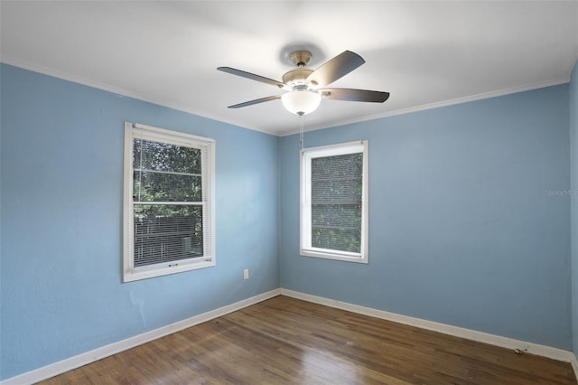 spare room with ceiling fan, a healthy amount of sunlight, crown molding, and dark wood-type flooring