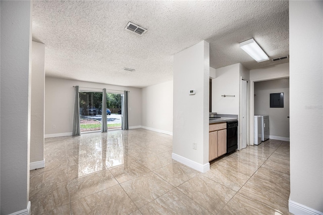 kitchen with sink, electric panel, black dishwasher, a textured ceiling, and separate washer and dryer