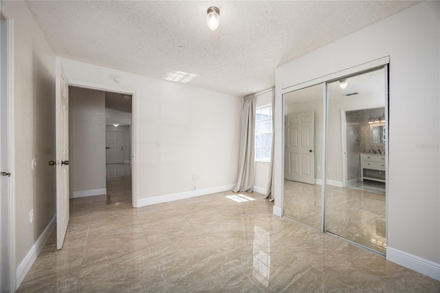 unfurnished bedroom featuring a closet and a textured ceiling