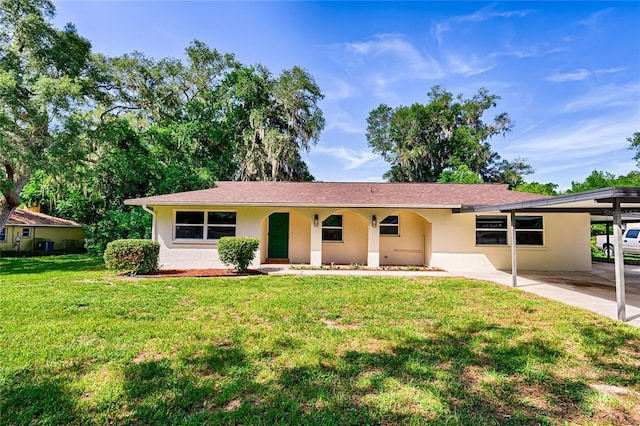 ranch-style home with a carport and a front lawn