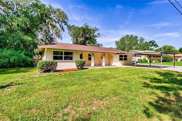 single story home featuring a carport and a front yard