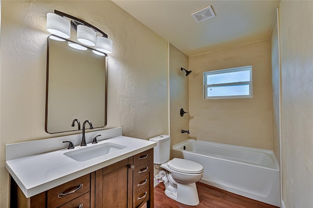 full bathroom featuring shower / washtub combination, wood-type flooring, toilet, and vanity